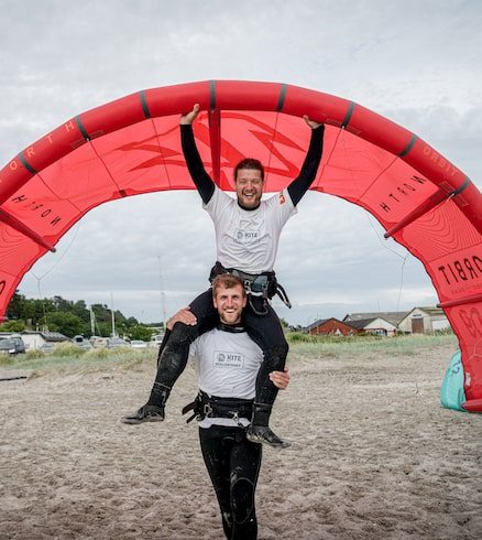 Two men kite surfing on the beach at Amager.